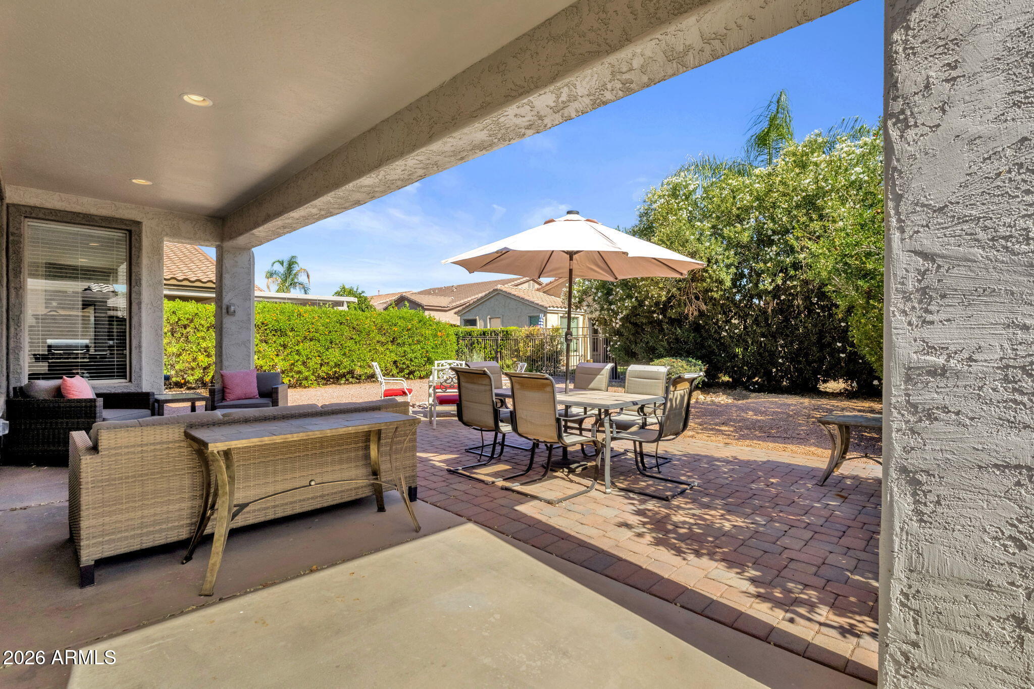 4094 East Azalea Drive Gilbert, AZ 85298 - Photo 17 of 21 a view of living room kitchen with furniture and table under an umbrella