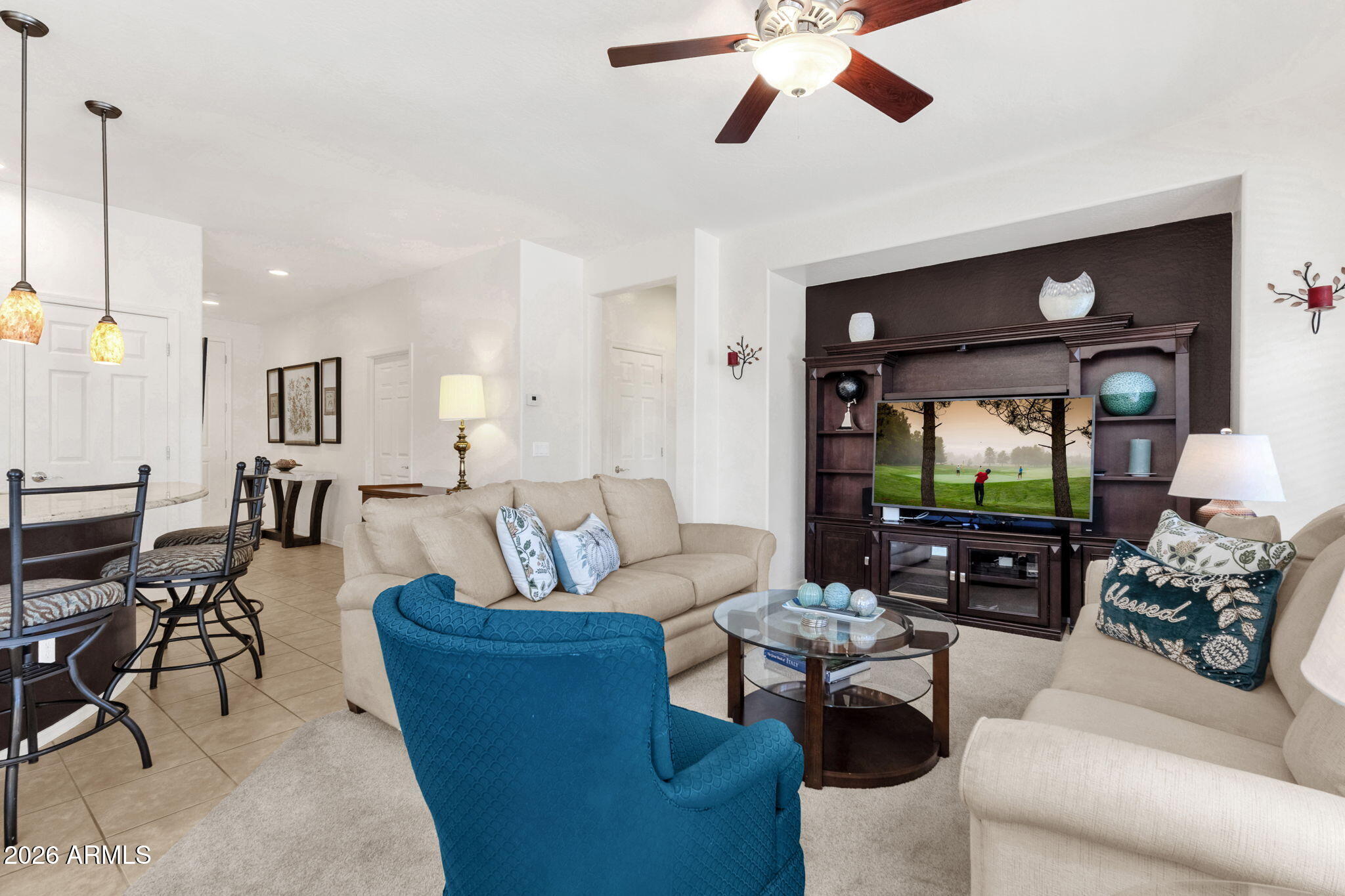 4094 East Azalea Drive Gilbert, AZ 85298 - Photo 6 of 21 a living room with furniture a ceiling fan and a flat screen tv