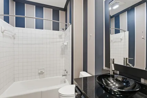 a bathroom with a bathtub and a toilet