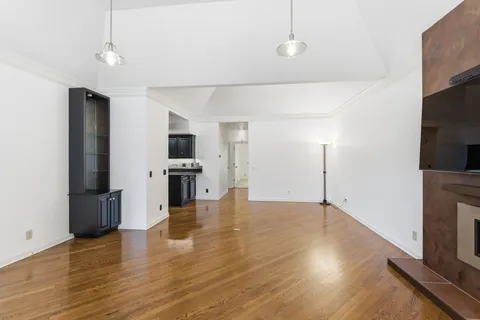 a view of a kitchen with stove and wooden floor