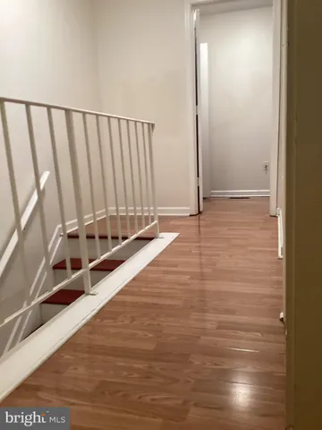 a view of a room with wooden floor