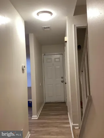 en view of a hallway with wooden floor