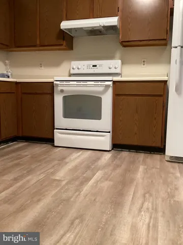 a stove top oven sitting inside of a kitchen