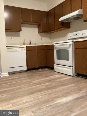 a kitchen with stainless steel appliances granite countertop a stove a microwave and a refrigerator