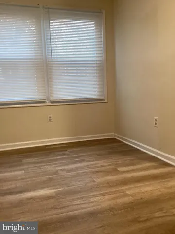 a view of a room with wooden floor and windows