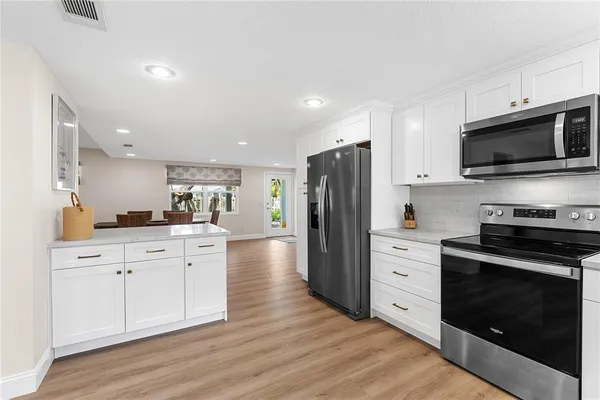 a kitchen with stainless steel appliances a stove microwave and refrigerator