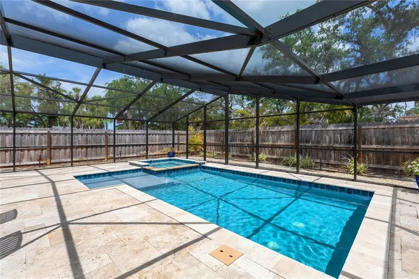 a view of a backyard with a large umbrella and wooden floor