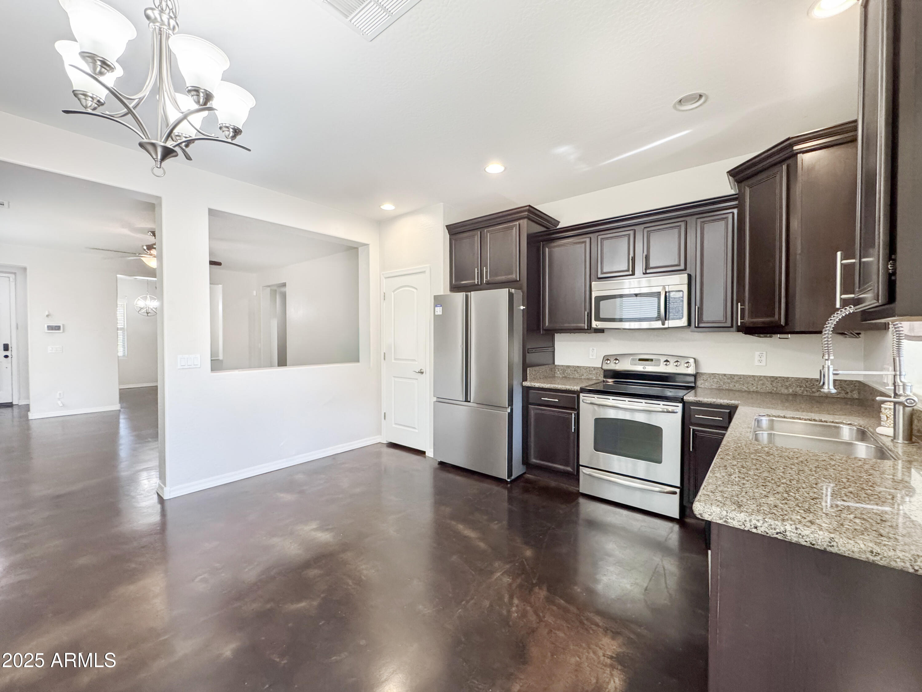 3141 East Patrick Street Gilbert, AZ 85295 - Photo 11 of 32 a kitchen with kitchen island granite countertop stainless steel appliances cabinets a sink and a counter top space