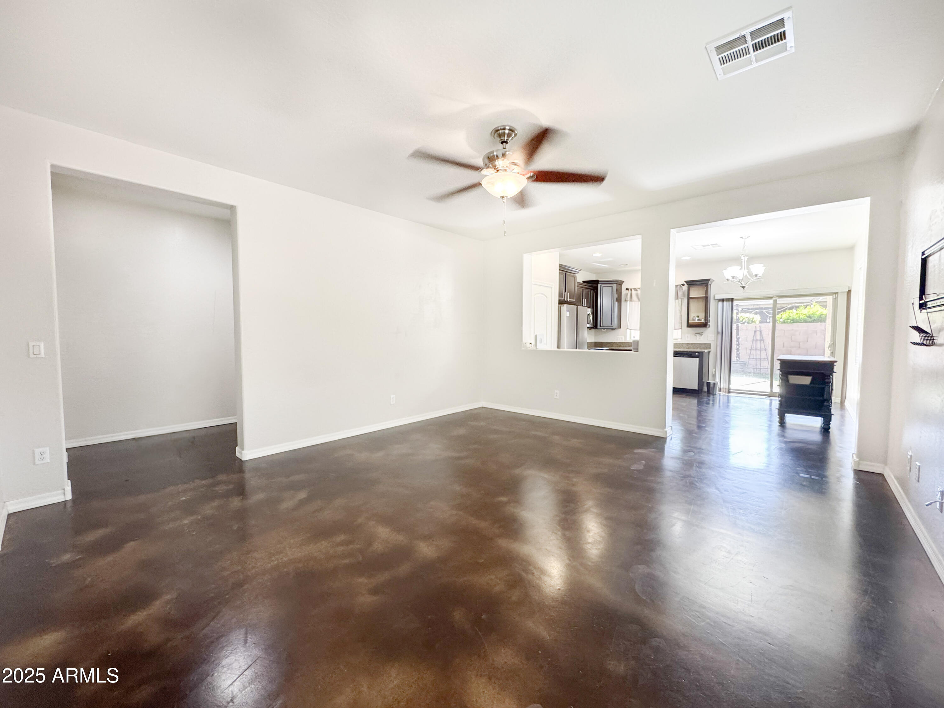 3141 East Patrick Street Gilbert, AZ 85295 - Photo 6 of 32 a view of a livingroom with wooden floor and a ceiling fan