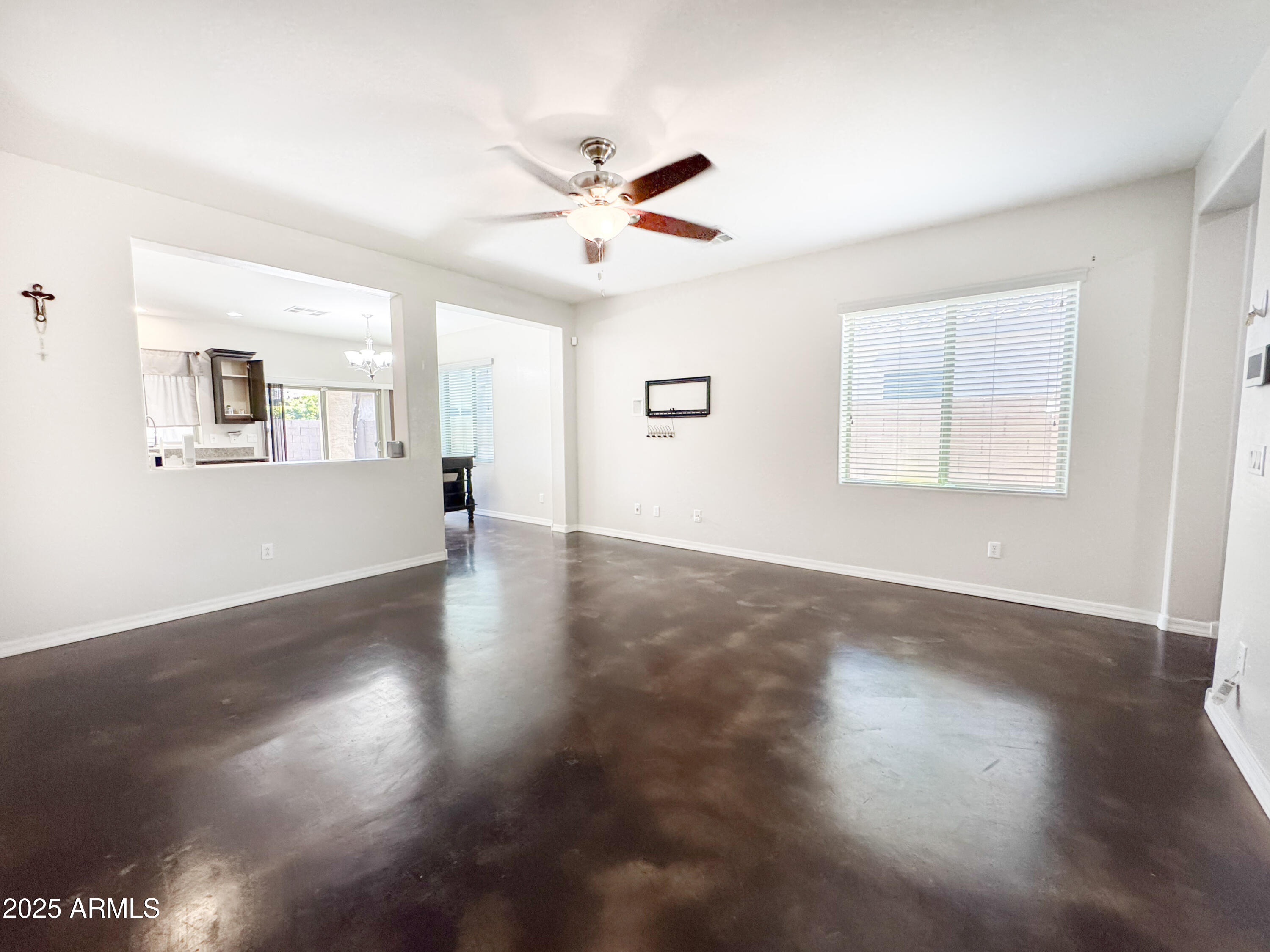 3141 East Patrick Street Gilbert, AZ 85295 - Photo 7 of 32 a view of a livingroom with wooden floor and a ceiling fan
