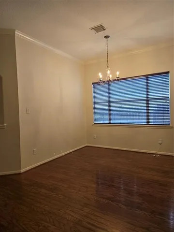 a view of wooden floor and windows in a room
