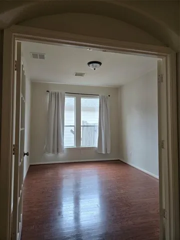 a view of wooden floor and windows in a room