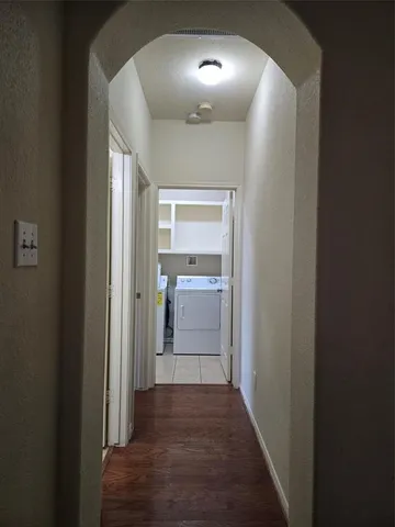 a view of a hallway to a livingroom and a hallway