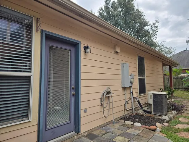 a side view of a house with a large window and chair