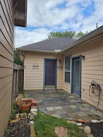 a backyard of a house with potted plants