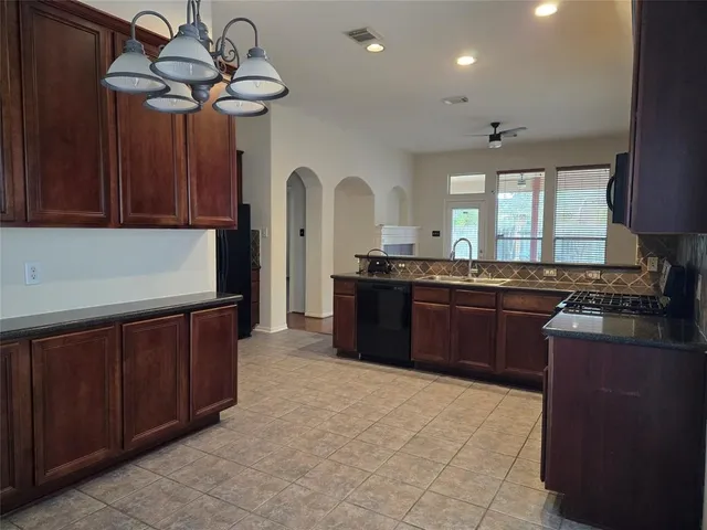 a kitchen with stainless steel appliances granite countertop a sink and cabinets