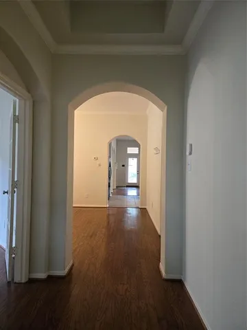 a view of a hallway with wooden floor