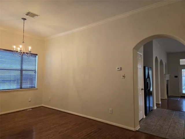 a view of a room with wooden floor and a ceiling fan