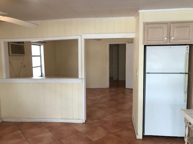1320 Virginia Street Key West, FL 33040 - Photo 4 of 11 a view of kitchen with a refrigerator cabinets and a window