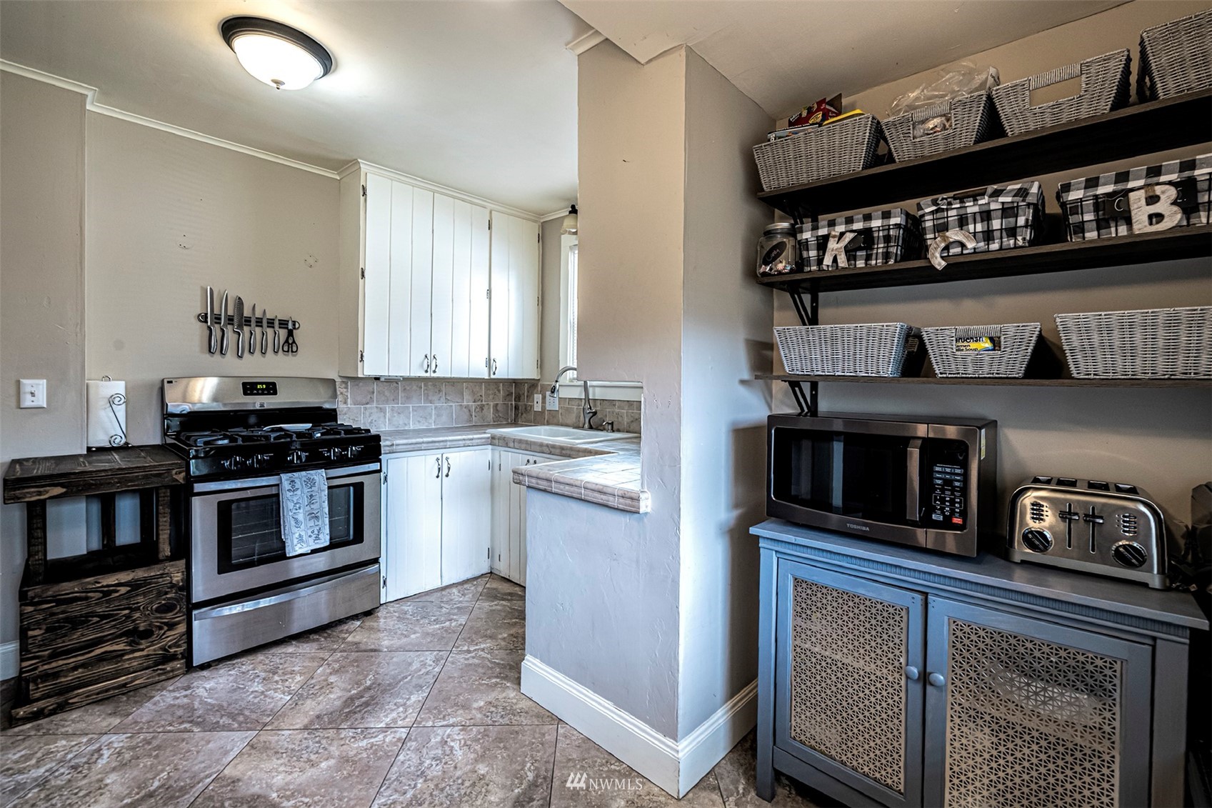 152 Locust Street Walla Walla, WA 99362 - Photo 15 of 38 a kitchen with stainless steel appliances granite countertop a stove and a microwave