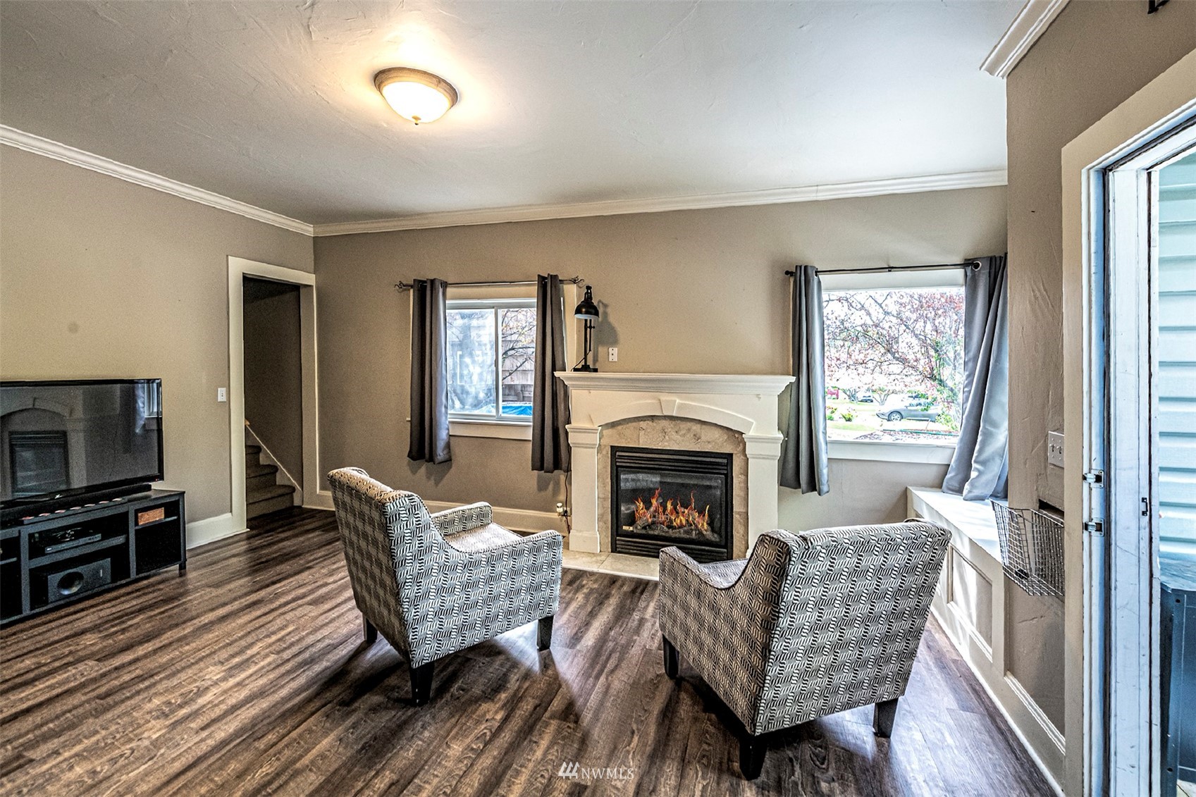 152 Locust Street Walla Walla, WA 99362 - Photo 6 of 38 a living room with furniture a flat screen tv and a fireplace
