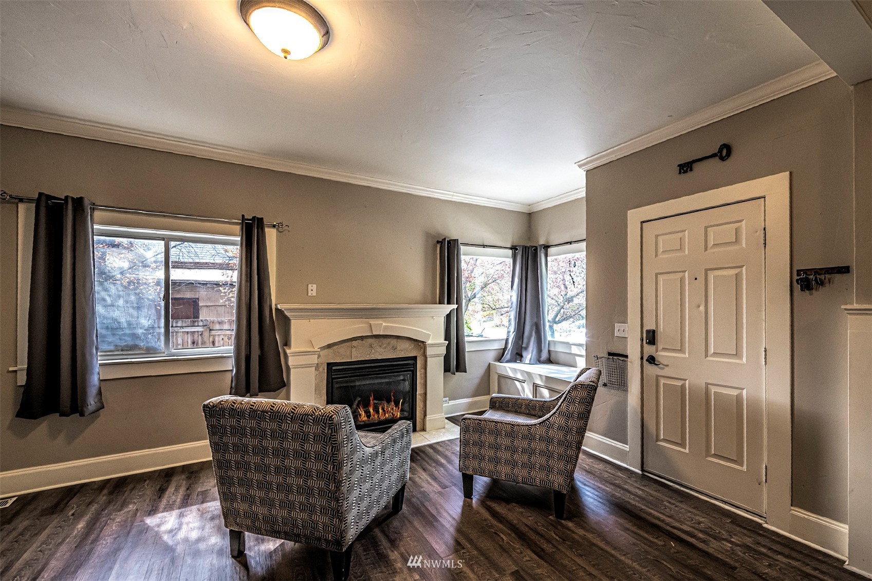 152 Locust Street Walla Walla, WA 99362 - Photo 9 of 38 a living room with furniture a fireplace and a floor to ceiling window
