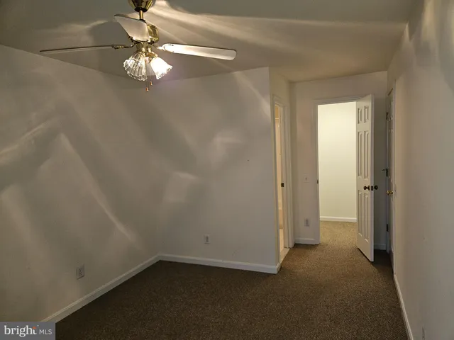 a view of a small space with a chandelier fan