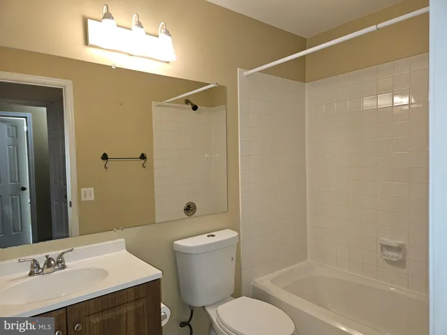 a bathroom with a sink toilet a mirror and shower
