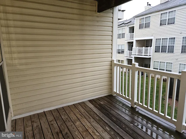 a view of a balcony with wooden floor