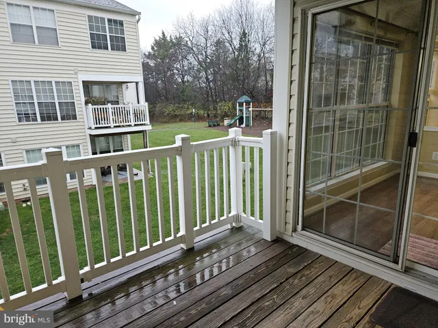 a view of a balcony with wooden floor