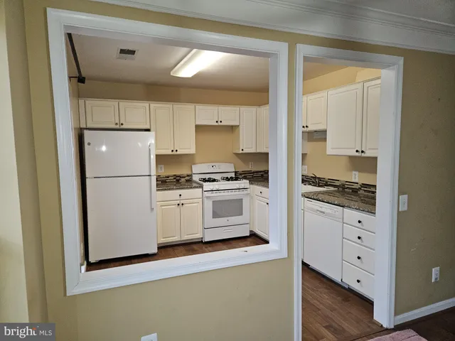 a kitchen with cabinets appliances and a window