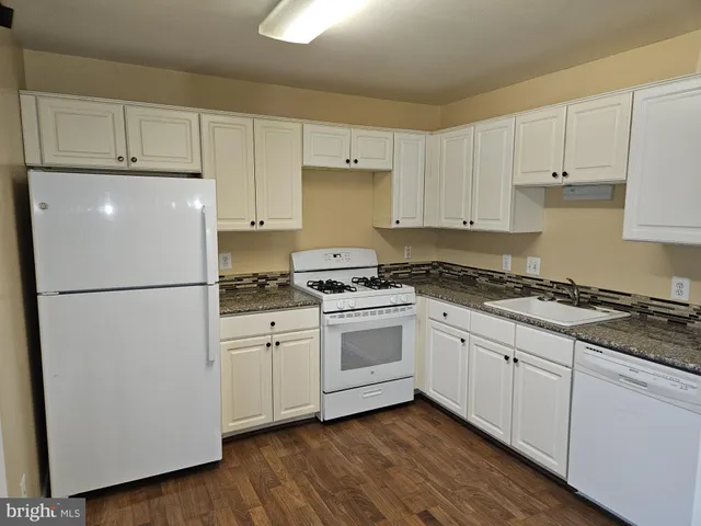 a white refrigerator freezer sitting inside of a kitchen