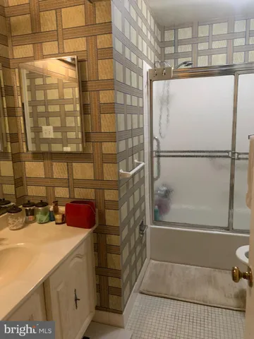 a bathroom with a shower and a sink