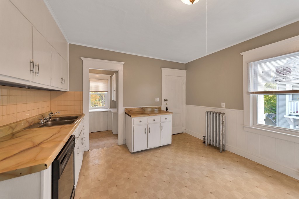 17-19 Standish Street Springfield, MA 01108 - Photo 11 of 20 a kitchen with a stove a sink a refrigerator and cabinets