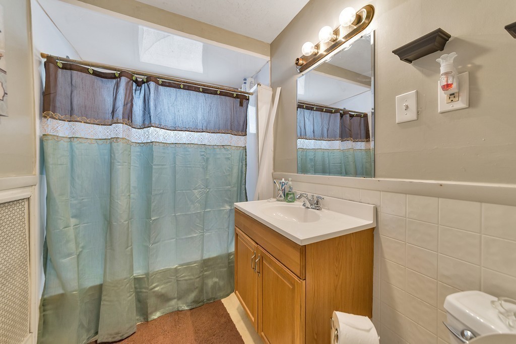 17-19 Standish Street Springfield, MA 01108 - Photo 15 of 20 a bathroom with a sink a toilet and shower