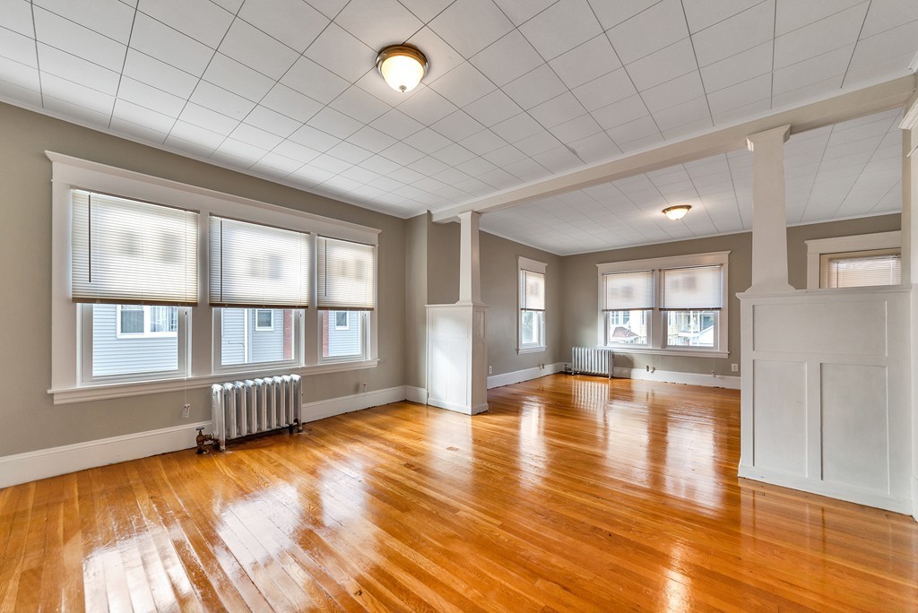 17-19 Standish Street Springfield, MA 01108 - Photo 4 of 20 a view of empty room with wooden floor and fan