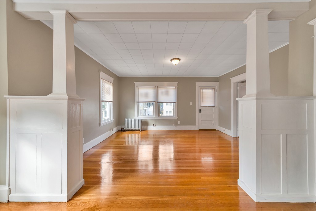 17-19 Standish Street Springfield, MA 01108 - Photo 5 of 20 a view of empty room with wooden floor and fan
