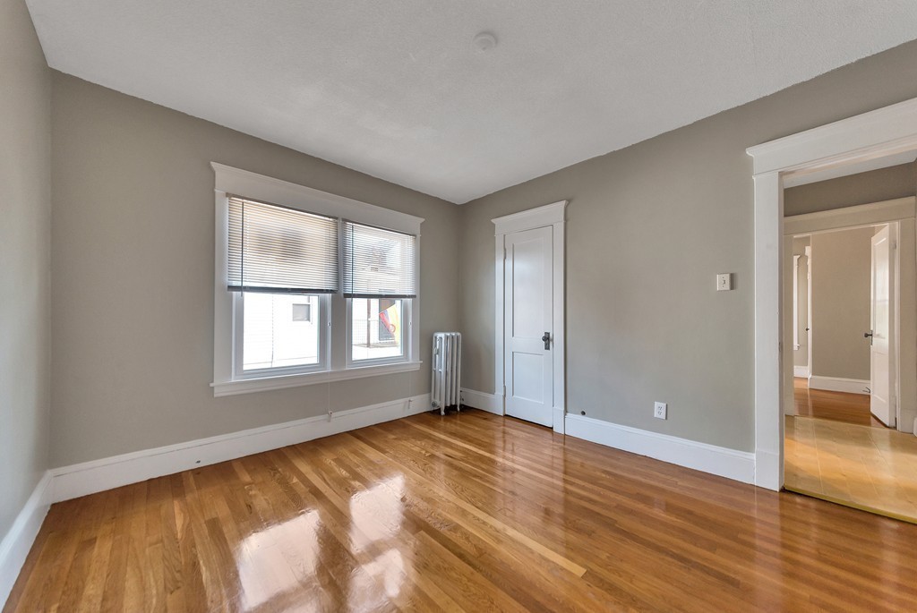 17-19 Standish Street Springfield, MA 01108 - Photo 8 of 20 a view of empty room with wooden floor and fan