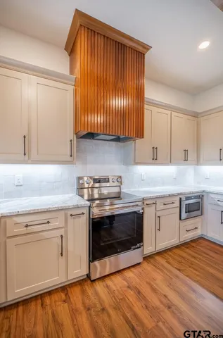 a kitchen with stainless steel appliances granite countertop a stove and a sink