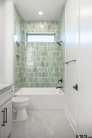 a bathroom with a shower and a toilet