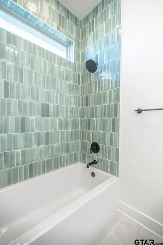 a bathroom with a bathtub and shower