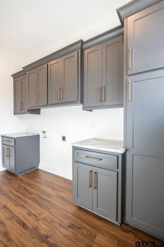 a kitchen with a sink cabinets and wooden floor