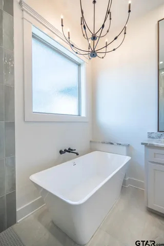 a white bath tub sitting next to a white sink