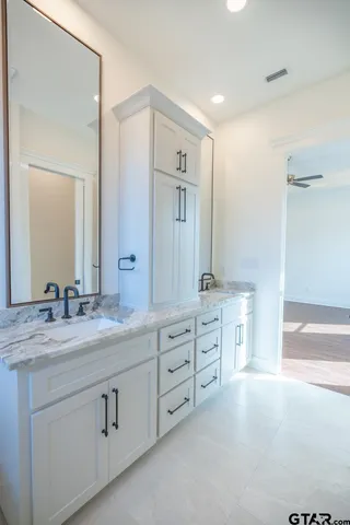 a spacious bathroom with a granite countertop sink mirror and double