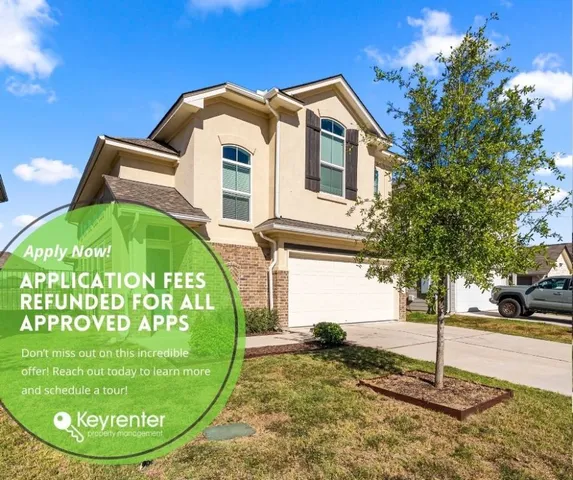 a view of a wooden house with a sink and yard