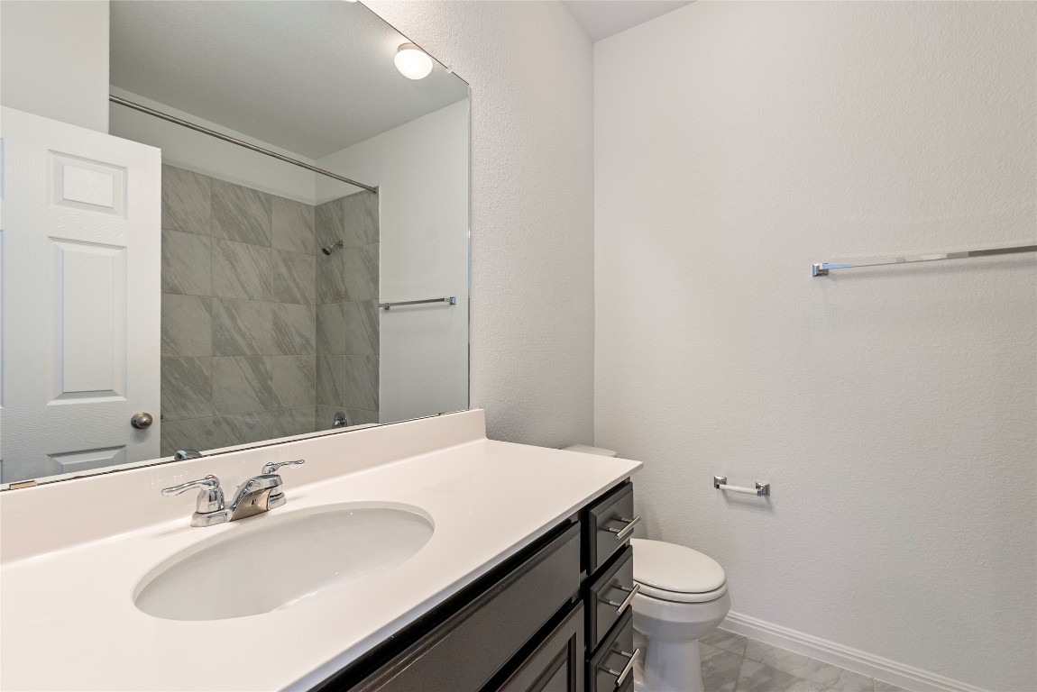 10704 Sentinel Drive Austin, TX 78747 - Photo 15 of 22 Bathroom featuring vanity and a shower