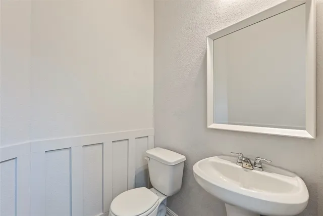 an empty room with a window and a ceiling fan