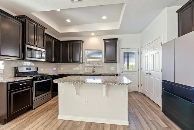a view of kitchen with microwave and cabinets