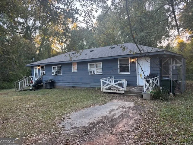 a view of a house with a yard and sitting area