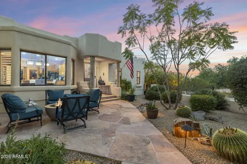 a view of a patio with couches table and chairs and potted plants